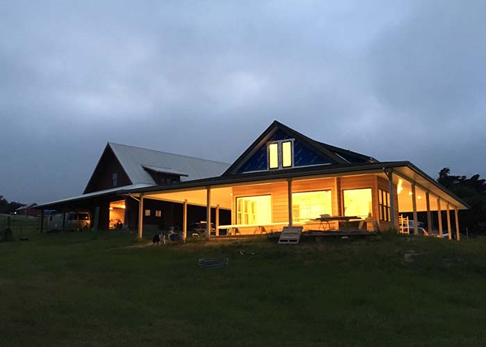 View of house at dusk with interior lighting on