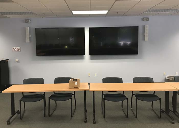 Conference room with two TVs mounted on the wall